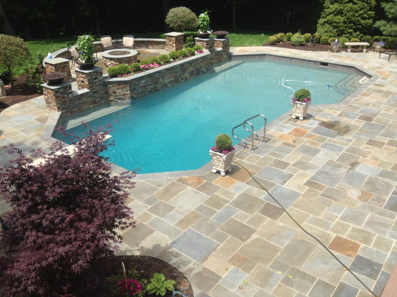 Custom gunite pool with stone patio in Southeast Michigan